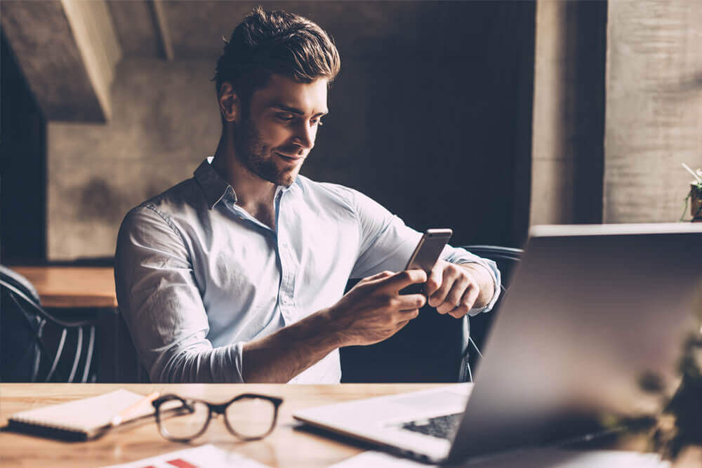 business man texting on phone